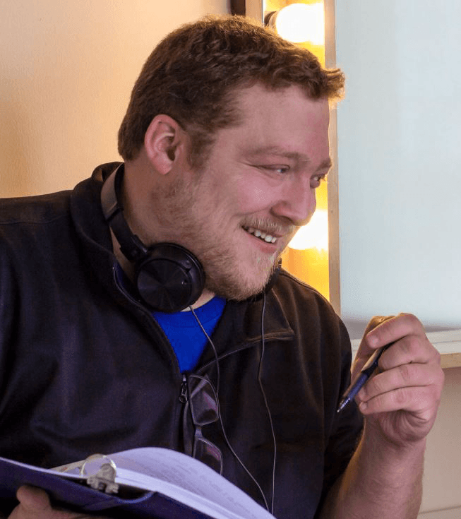 Chris Lang coaching on set, laughing